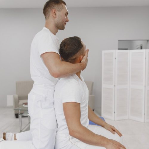 man-medical-office-physiotherapist-is-rehabilitating-back_1157-43676